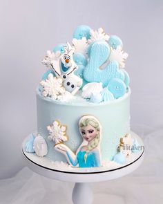 a frozen princess cake with frosting and decorations