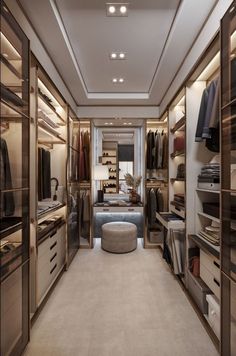 a walk in closet with lots of drawers and clothes hanging on the walls, along with a round mirror