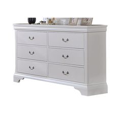 a white dresser with several drawers and pictures on it's top shelf, against a white background