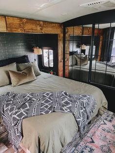 a large bed sitting inside of a bedroom next to a mirror