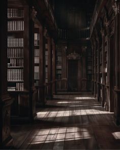 an empty library with lots of bookshelves in the middle and light coming through