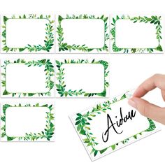 a hand holding a name tag with green leaves on it and the word adida written in cursive writing