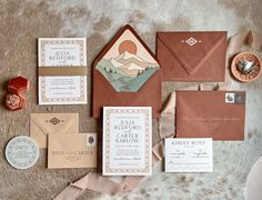 the wedding stationery is laid out on top of the furnishing, including an envelope and matching cards