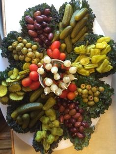 a white plate topped with lots of different types of veggies on top of a table