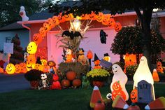 halloween decorations in front of a house with pumpkins and jack - o'- lanterns