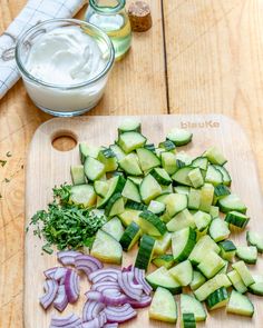 chopped cucumbers and onions on a cutting board