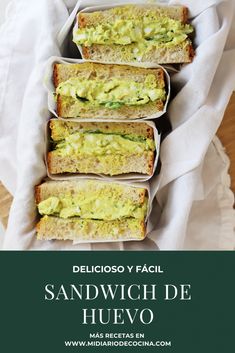 sandwiches with guacamole and cheese on them are stacked in a paper tray