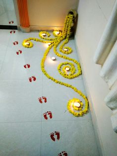 a floor decorated with yellow flowers and candles in the shape of an elephant's paw