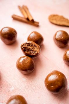 chocolate candies and cinnamon sticks on a pink surface