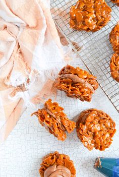 some cookies are cooling on a rack and one is covered in caramel icing