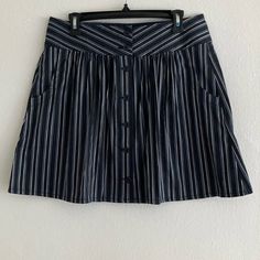 This Pinstripe Mini Comes In X-Small, Small, Medium & Large Gathered Front Button Down Front Closure Functional Pockets Black And White Comes With A Spare Button Lay Flat Measurements X-Small: -Waist 13” -Length 17 1/2” Small: -Waist 14” -Length 17 1/2” Medium: -Waist 15” -Length 18” Large: -Waist 16” -Length 18” Striped Cotton Bottoms With Buttons, Striped Bottoms With Buttons For Summer, Striped Summer Bottoms With Buttons, Striped Lined Skort For Summer, Summer Striped Lined Skort, Striped Cotton Bottoms With Button Closure, Short Striped Skirt For Spring, Casual Striped Fitted Mini Skirt, Casual Striped Skirt For Workwear