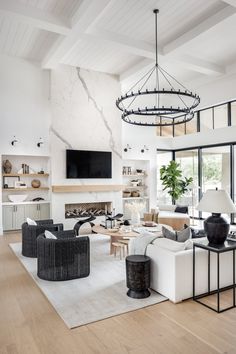 a living room filled with lots of furniture and a flat screen tv mounted to the wall