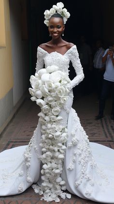 a woman in a wedding dress made out of flowers