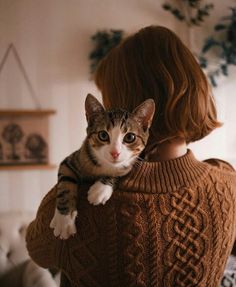 a woman holding a cat in her arms