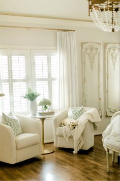 a living room filled with furniture and a chandelier