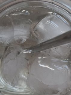 ice cubes in a glass jar with a spoon