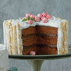 a cake with white frosting and candy canes on top