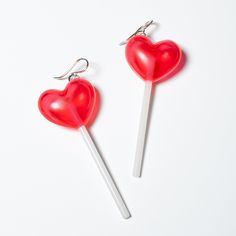 two heart shaped lollipops on a white background