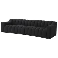 a long black couch sitting on top of a white floor