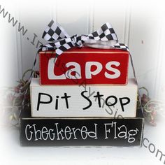 a stack of wooden blocks that say laps, pit stop and checkered flag