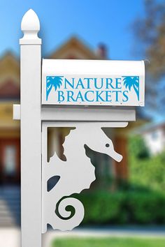 there is a sign that says nature brackets in front of a house with trees and bushes