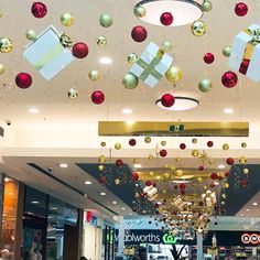 christmas decorations hanging from the ceiling in a shopping mall