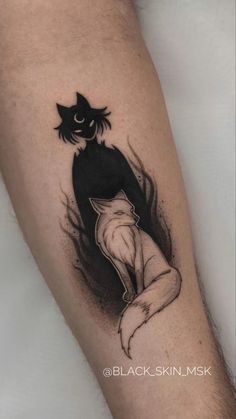 a black and white cat tattoo on the arm