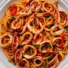 pasta with shrimp and tomato sauce in a white bowl