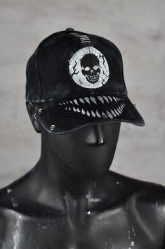 The cap in the photos has a distinctive post-apocalyptic and edgy design. It features a skull emblem in the center of the front panel, giving it a rebellious, dystopian aesthetic. The cap also has an aggressive set of white teeth painted on the brim, enhancing the fierce look. The fabric and design appear distressed, contributing to the post-apocalyptic style that fits within the aesthetic often used in Wasted Couture's work. Additionally, the cap is customized with metallic rivets or grommets a Dystopian Aesthetic, Smile White, Gothic Streetwear, Creepy Smile, Edgy Design, Style Punk, White Teeth, Punk Style, Post Apocalyptic