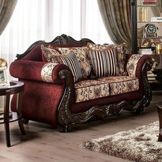 a living room filled with furniture next to a window covered in curtained drapes