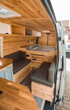 the interior of a camper van with wood paneling