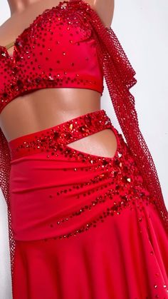 a woman wearing a red dress with sequins on it