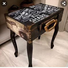 an old trunk turned into a table with writing on it and gold handles, sitting in the corner of a room