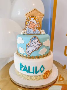 a three tiered cake with cartoon characters on it and balloons in the back ground