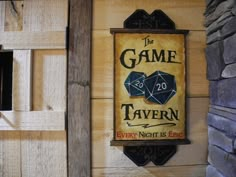 a sign that is on the side of a building saying the game tavern every night is epic