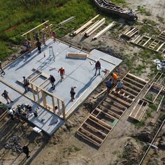 construction workers are working on the roof of an unfinished building in preparation to be built