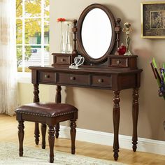 a dressing table with a mirror and stool