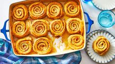 a pan filled with cinnamon rolls on top of a table