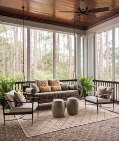 a screen shot of a sun room with couches, chairs and tables in it