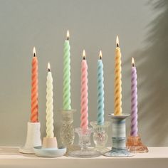 there are many different colored candles next to each other