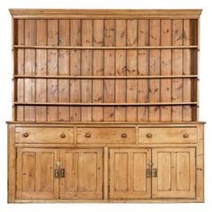 an old wooden bookcase with drawers and cupboards