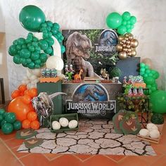 an assortment of balloons and decorations for a dinosaur birthday party