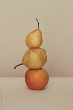 three pears stacked on top of each other in the shape of a pyramid by jordi for stocks