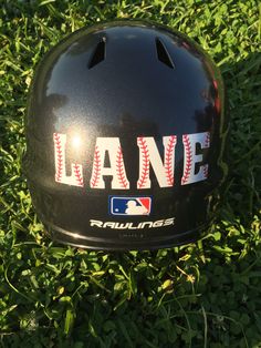 a baseball helmet sitting in the grass