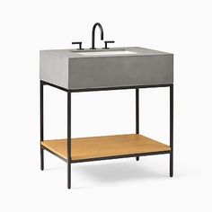 a sink with a wooden shelf underneath it and a faucet on the side