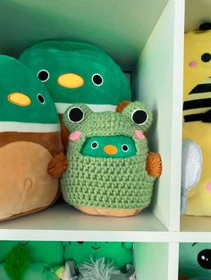 several stuffed animals are on shelves in a room with green and yellow walls, one is wearing a hat