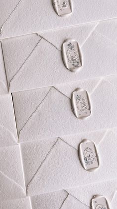 several stamps are placed on top of white envelopes