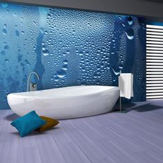 a white bath tub sitting next to a window covered in raindrops on the wall