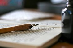 a pen sitting on top of an open book