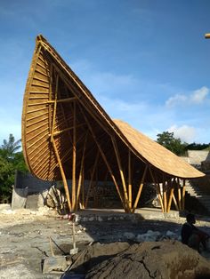 a large wooden structure sitting on top of a pile of dirt